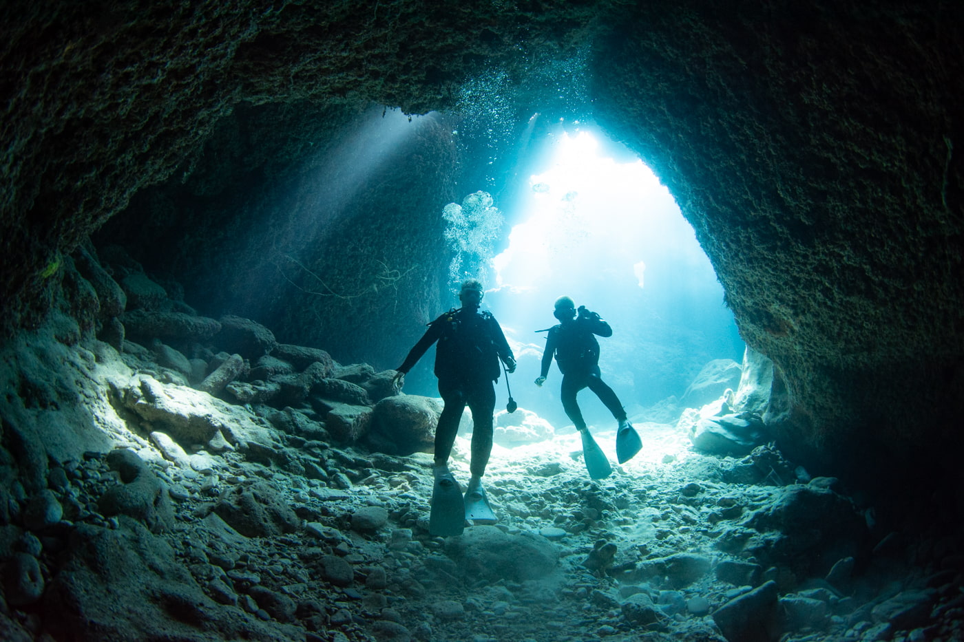 Guests diving inside a cave.