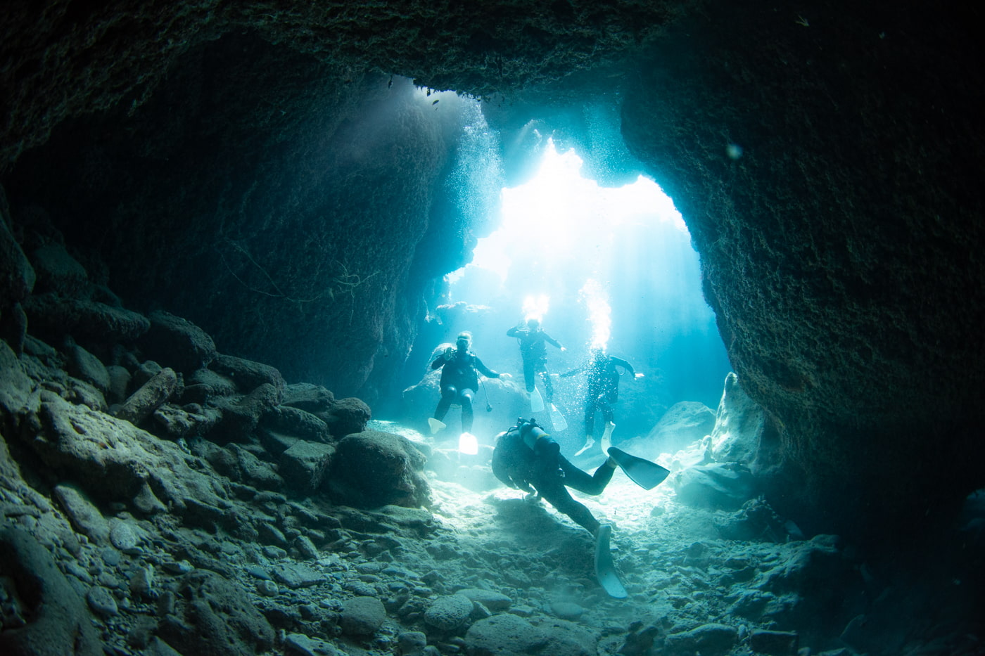 Guests diving inside a cave.