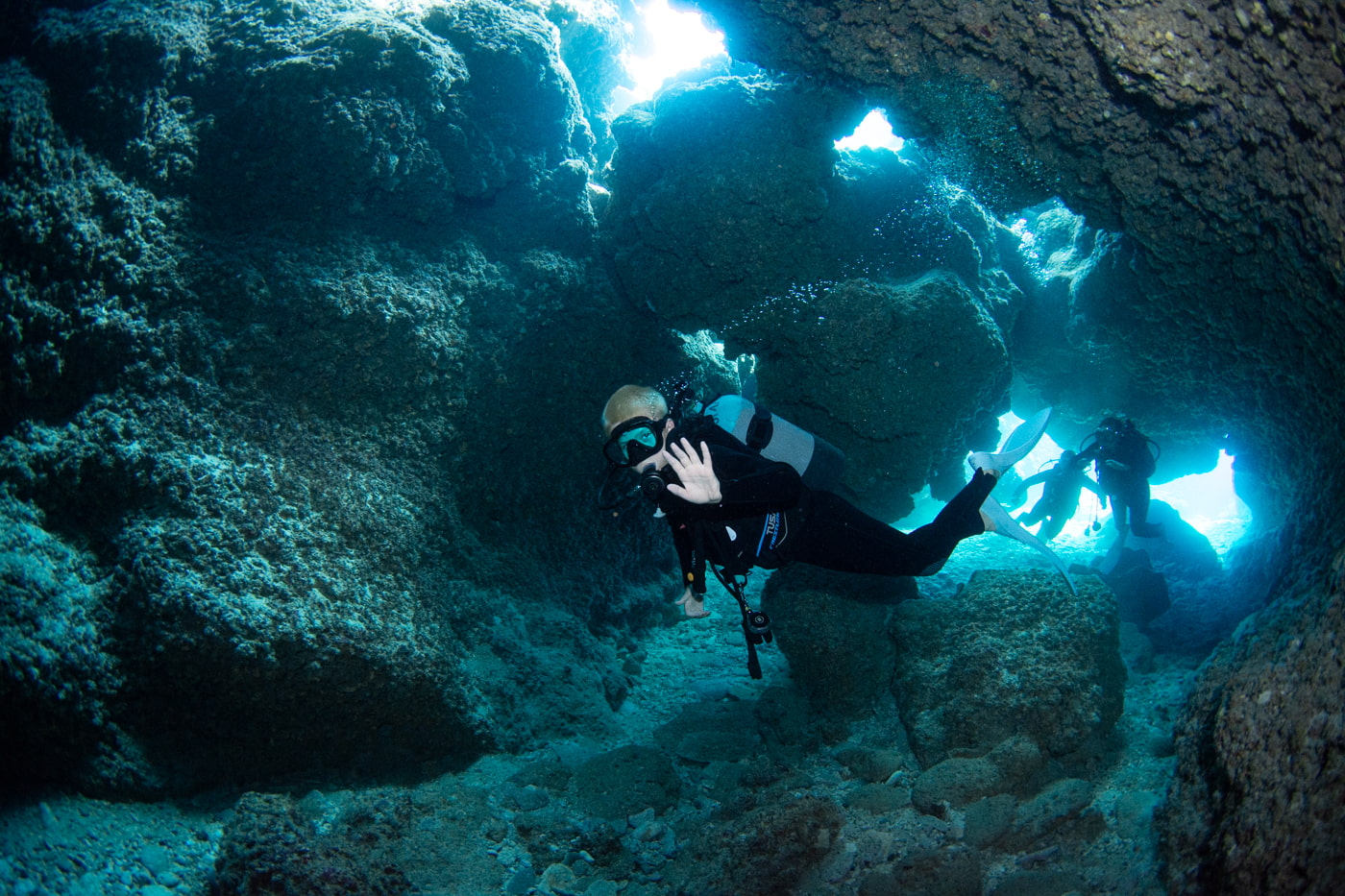Guests diving inside a cave.