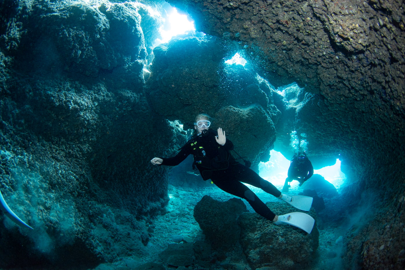 Guests diving inside a cave.