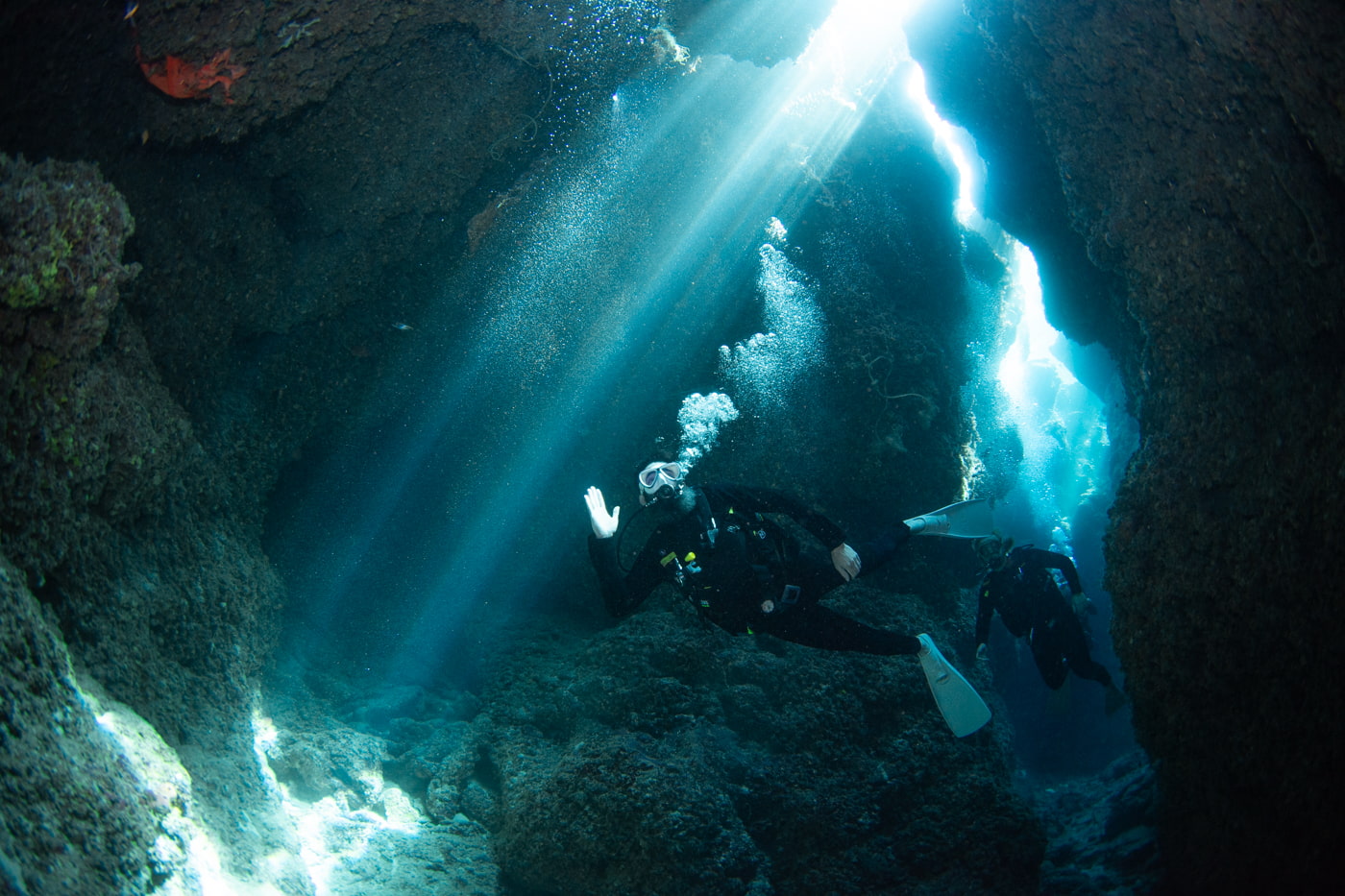 Guests diving inside a cave.