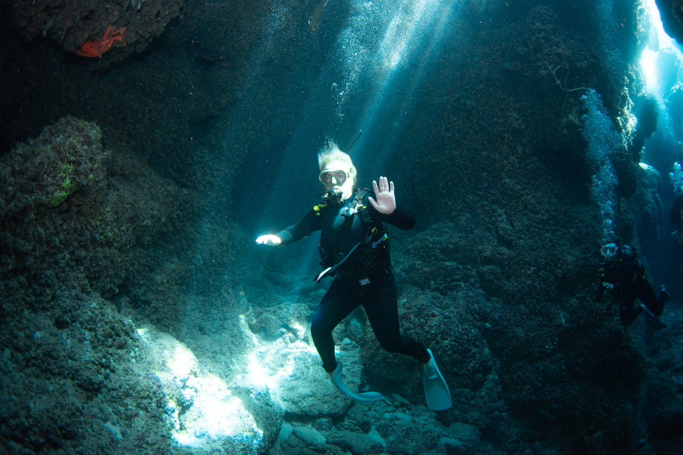 Guests diving inside a cave.