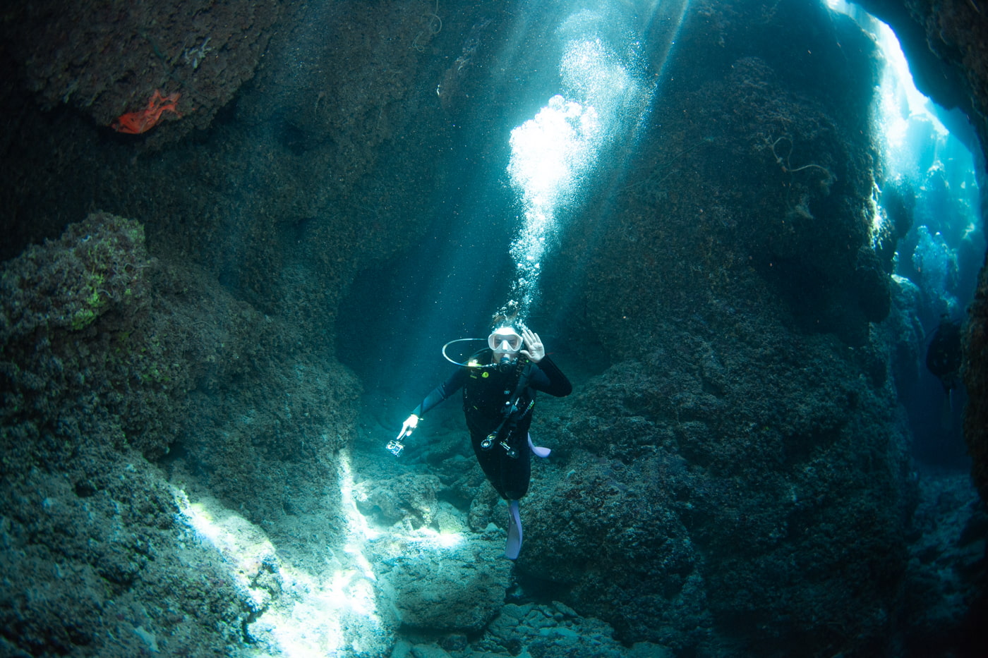 Guests diving inside a cave.