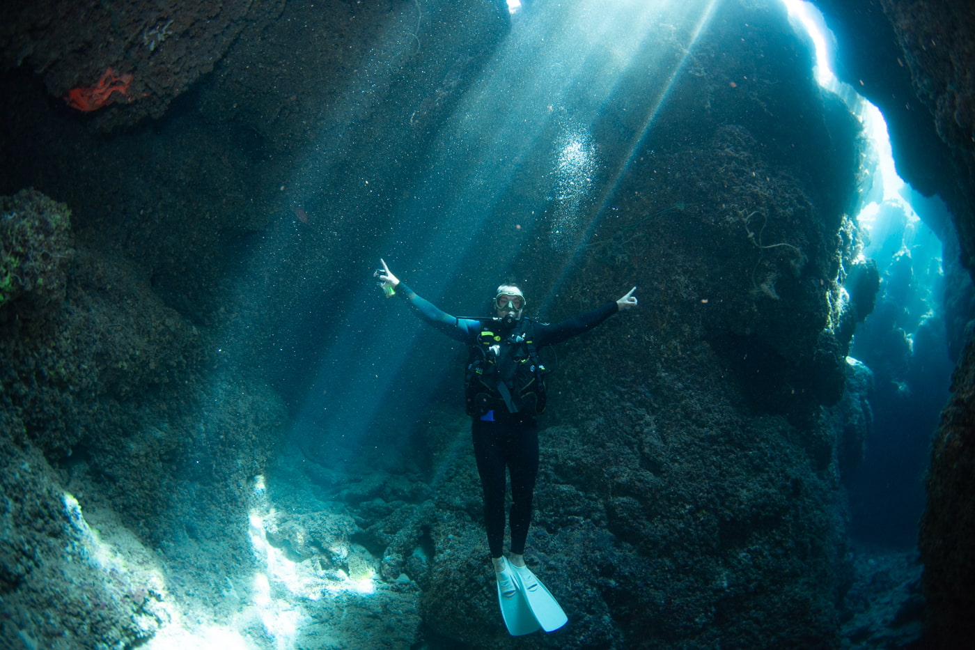Guests diving inside a cave.