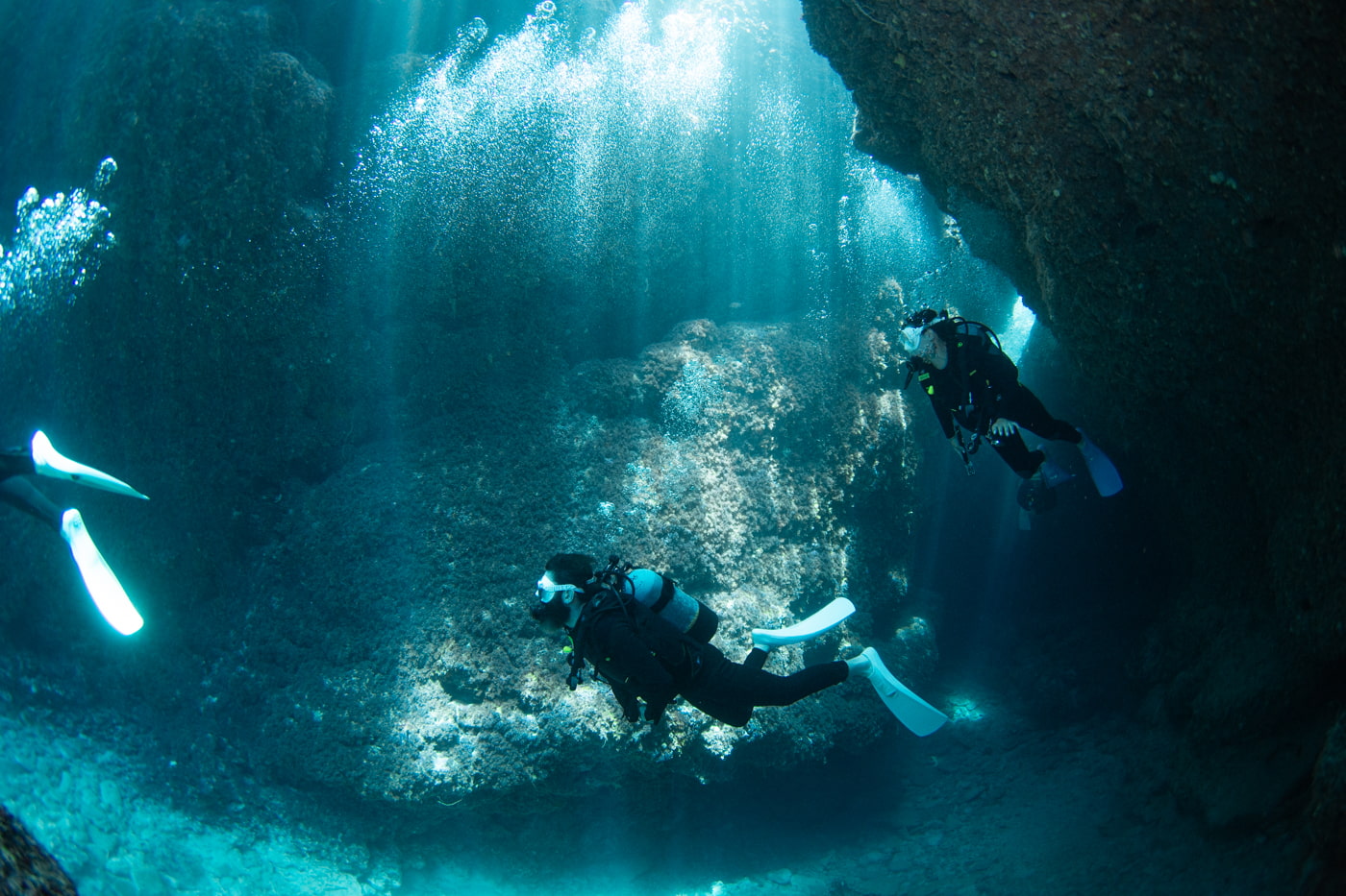 Guests diving inside a cave.
