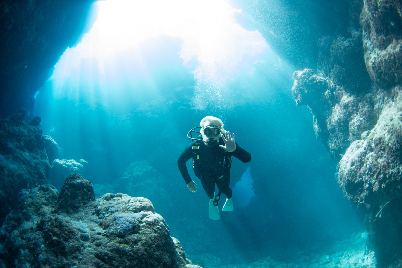 Guests diving inside a cave.