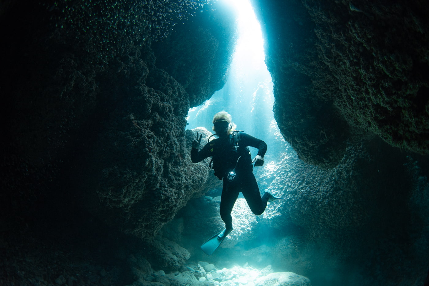 Guests diving inside a cave.