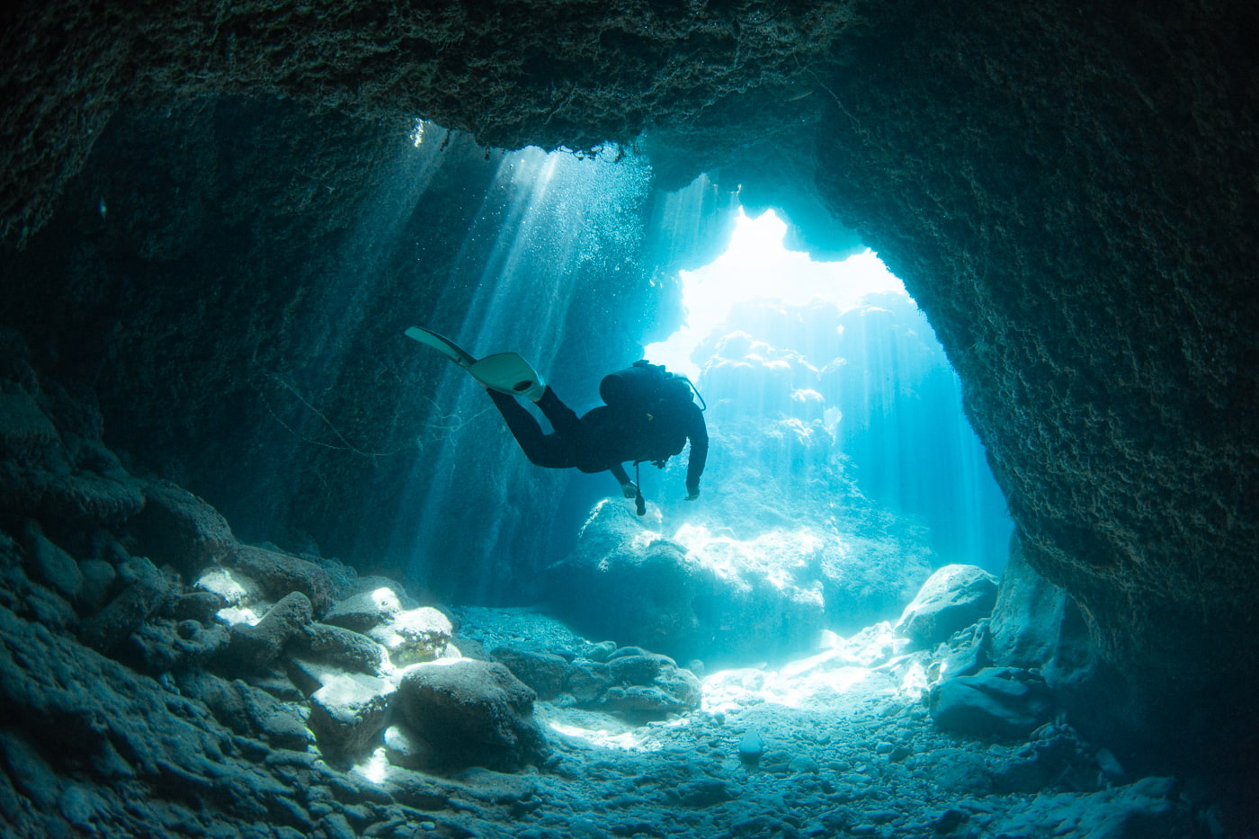Guests diving inside a cave.