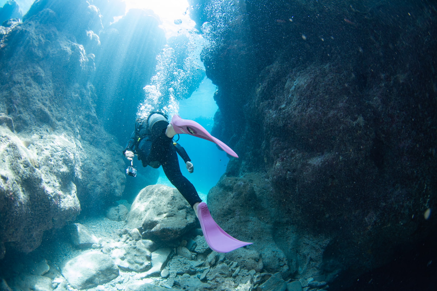 Guests diving inside a cave.