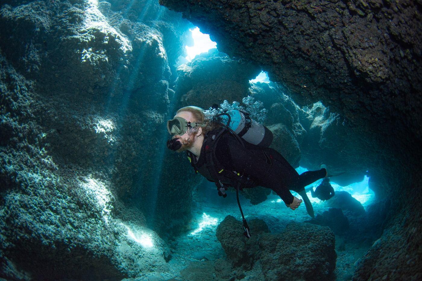 Guests diving inside a cave.