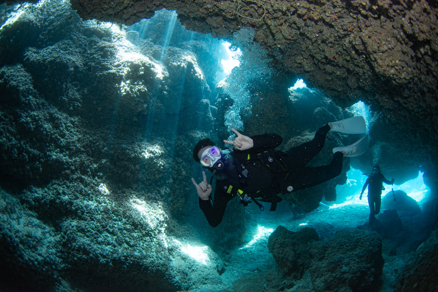 Guests diving inside a cave.