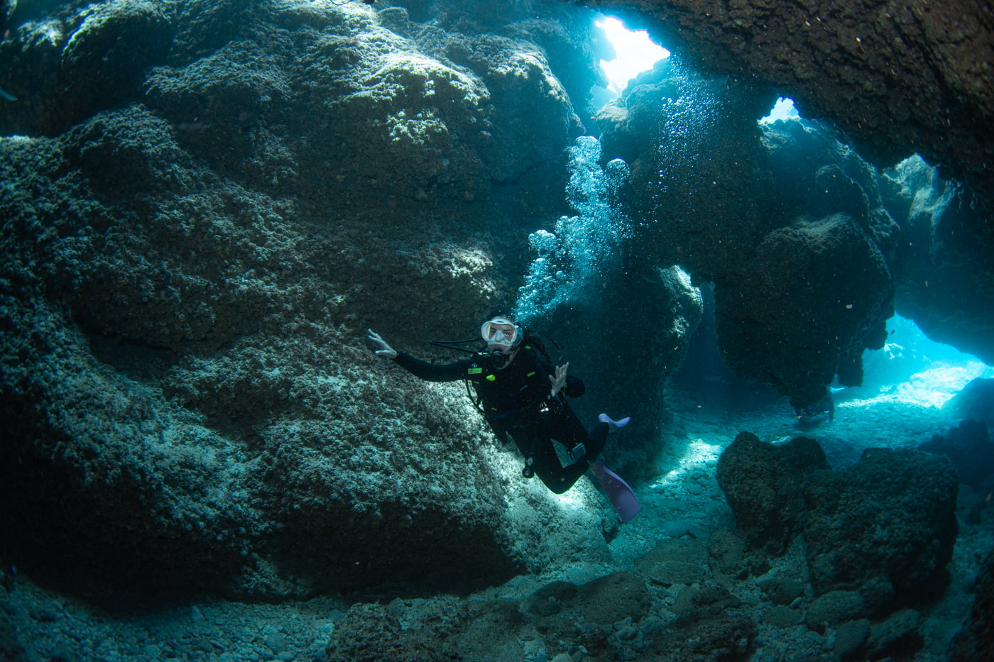 Guests diving inside a cave.