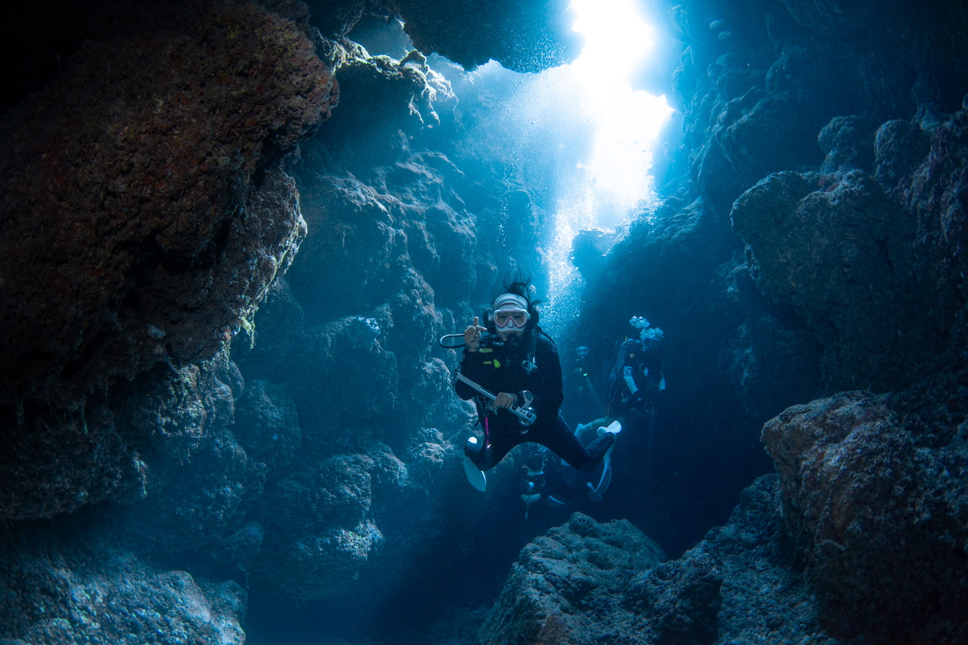 Guests diving inside a cave.