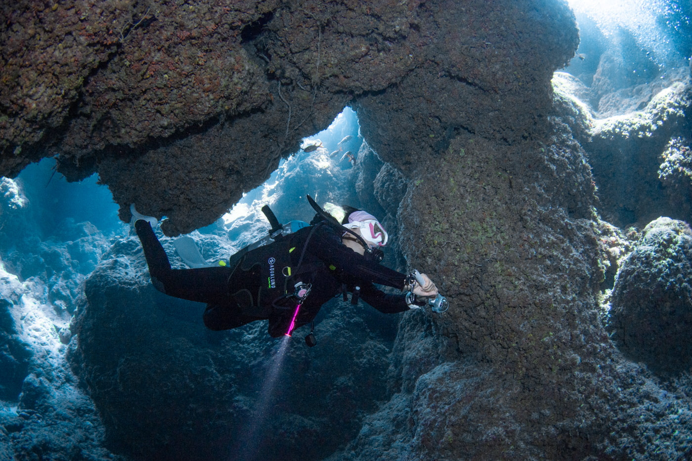Guests diving inside a cave.