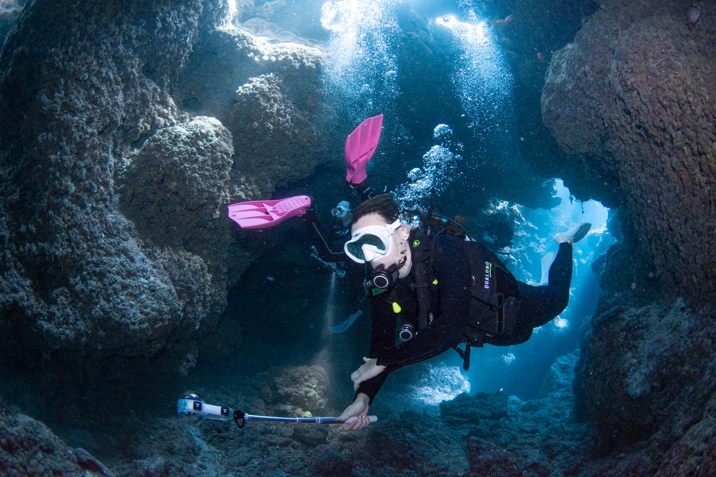 Guests diving inside a cave.