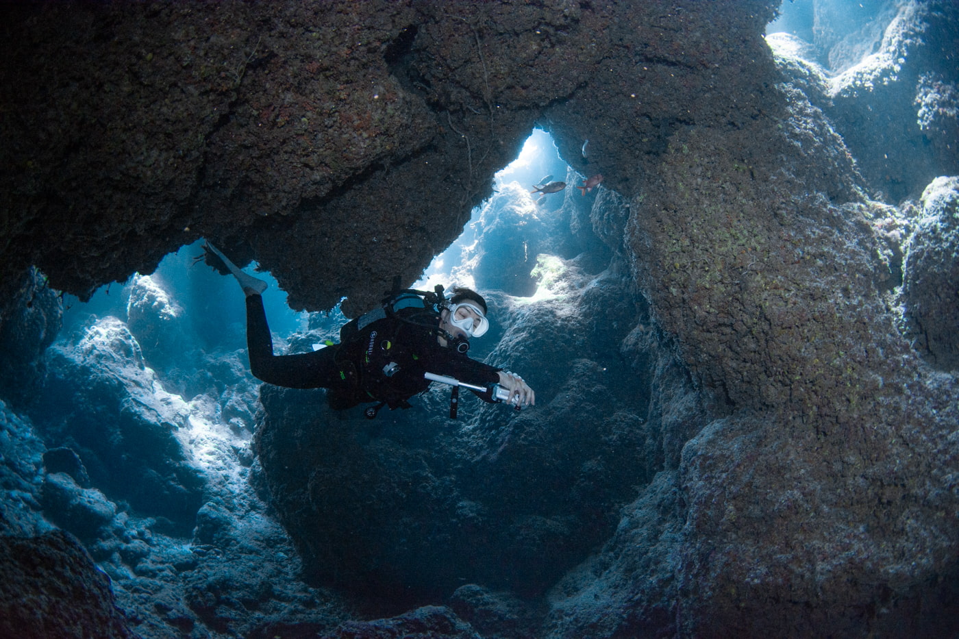 Guests diving inside a cave.