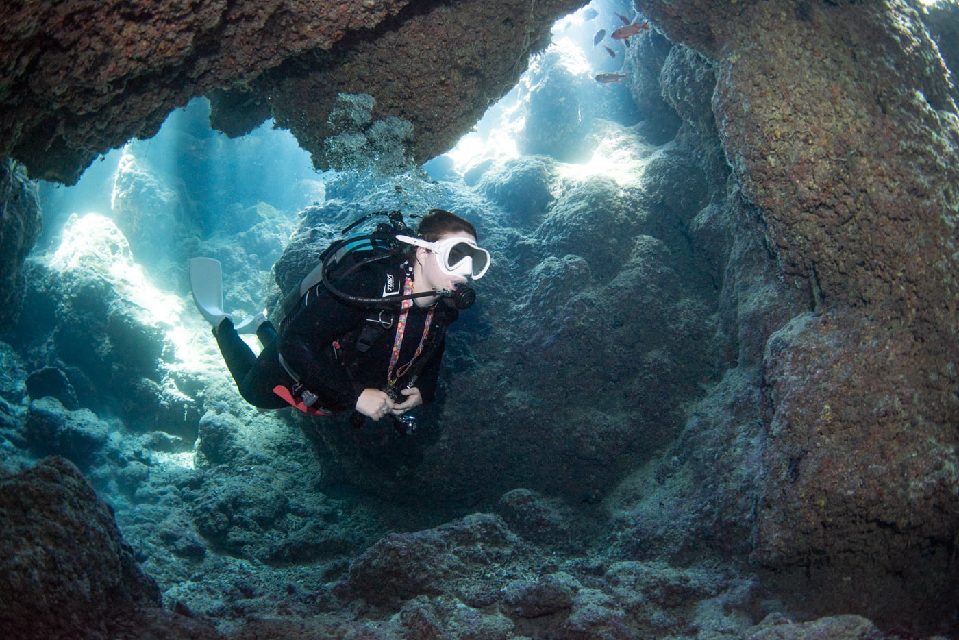 Guests diving inside a cave.