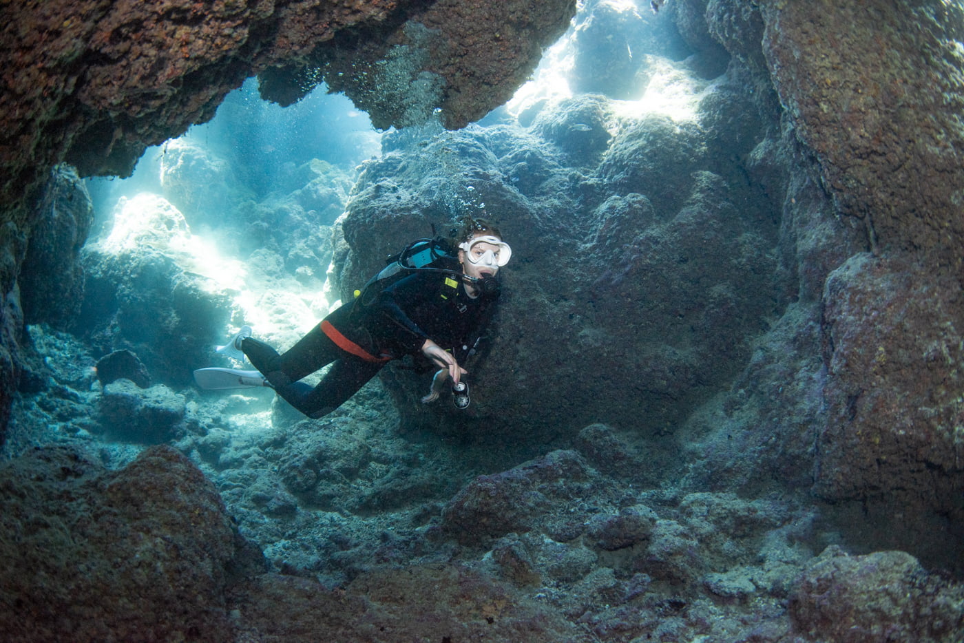 Guests diving inside a cave.