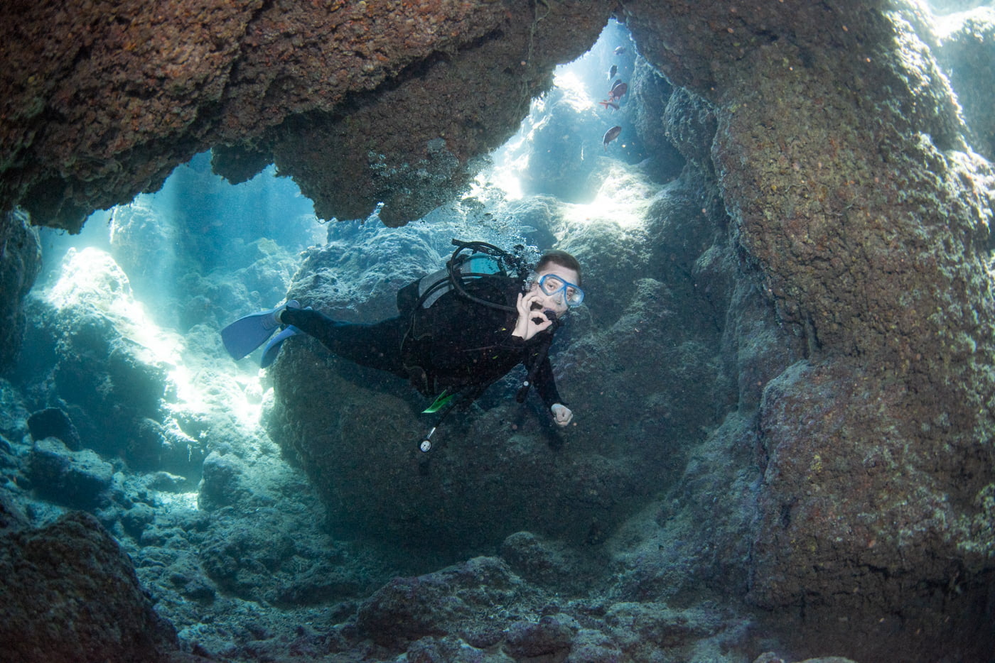 Guests diving inside a cave.