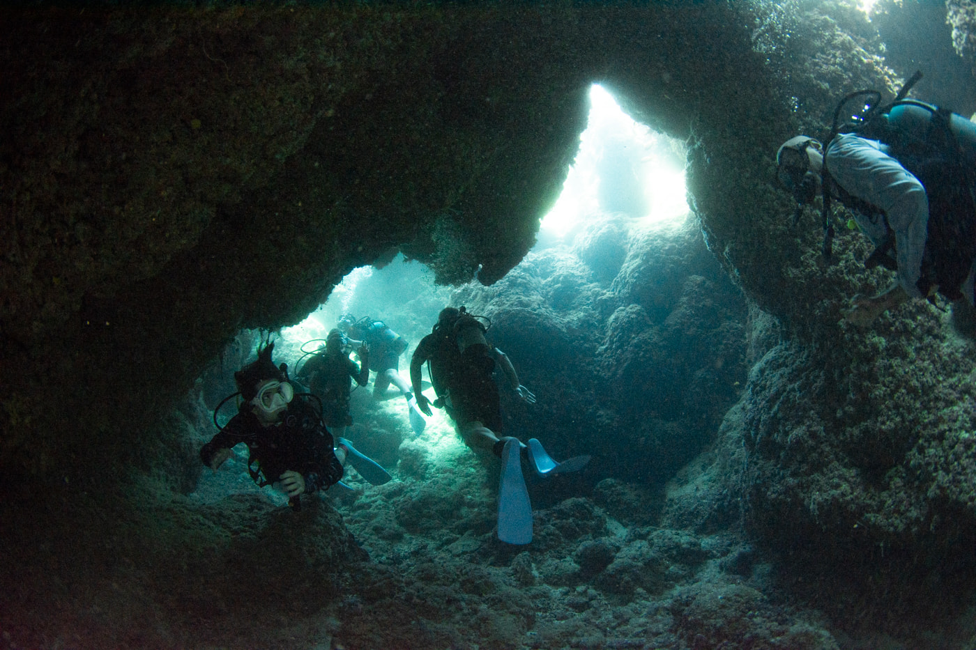 Guests diving inside a cave.