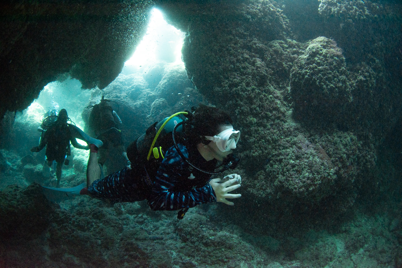 Guests diving inside a cave.